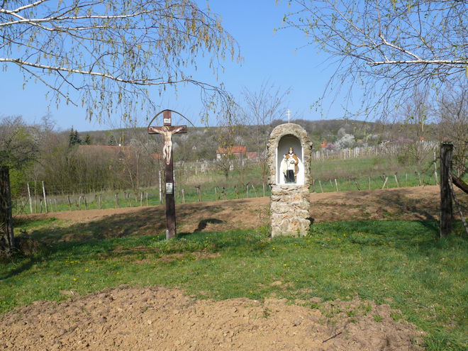 Wooden wayside cross and chapel with the statue of St Urban at the entrance to the Ladice vineyards 