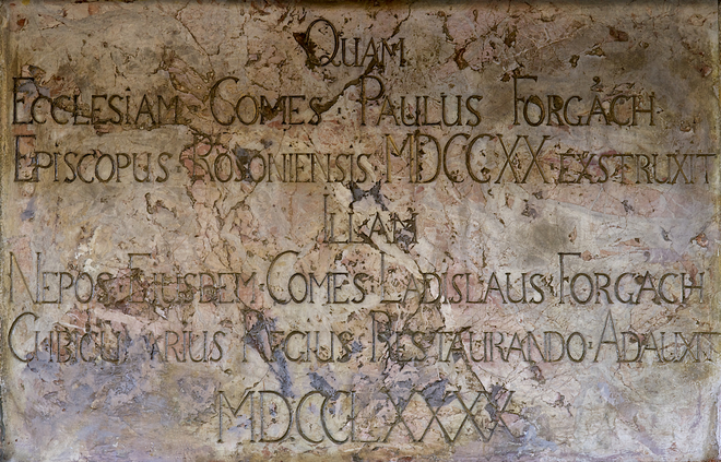 Plaque above the main entrance to the Church of the Holy Cross: ‘Quam Ecclesiam Comes Paulus Forgach Episcopus Rosoniensis MDCCXX Extruxit IIIam Nepos Eiusdem Comes Ladislaus Forgach Cubicularius Regius. Restaurando Adauxit MDCCLXXXX’ (This church was erected by Count Paulus Forgach, bishop of Roson, in 1720, renewed by his grandson Count Ladislaus Forgach, royal chamberlain in 1790)