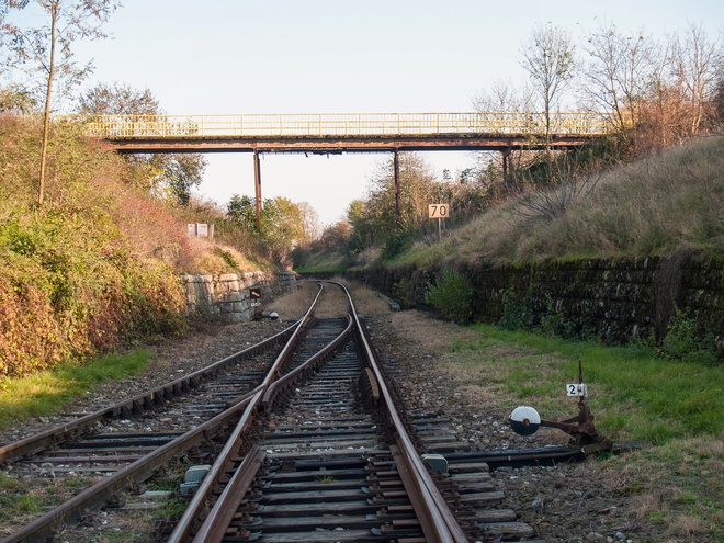 Steel bridge paved with wooden sleepers above the railway