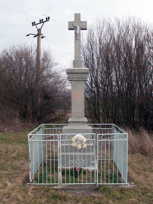 Kríž prícestný s korpusom na ceste do Velčíc zo Slažian z roku 1963, obnovený v roku 2012